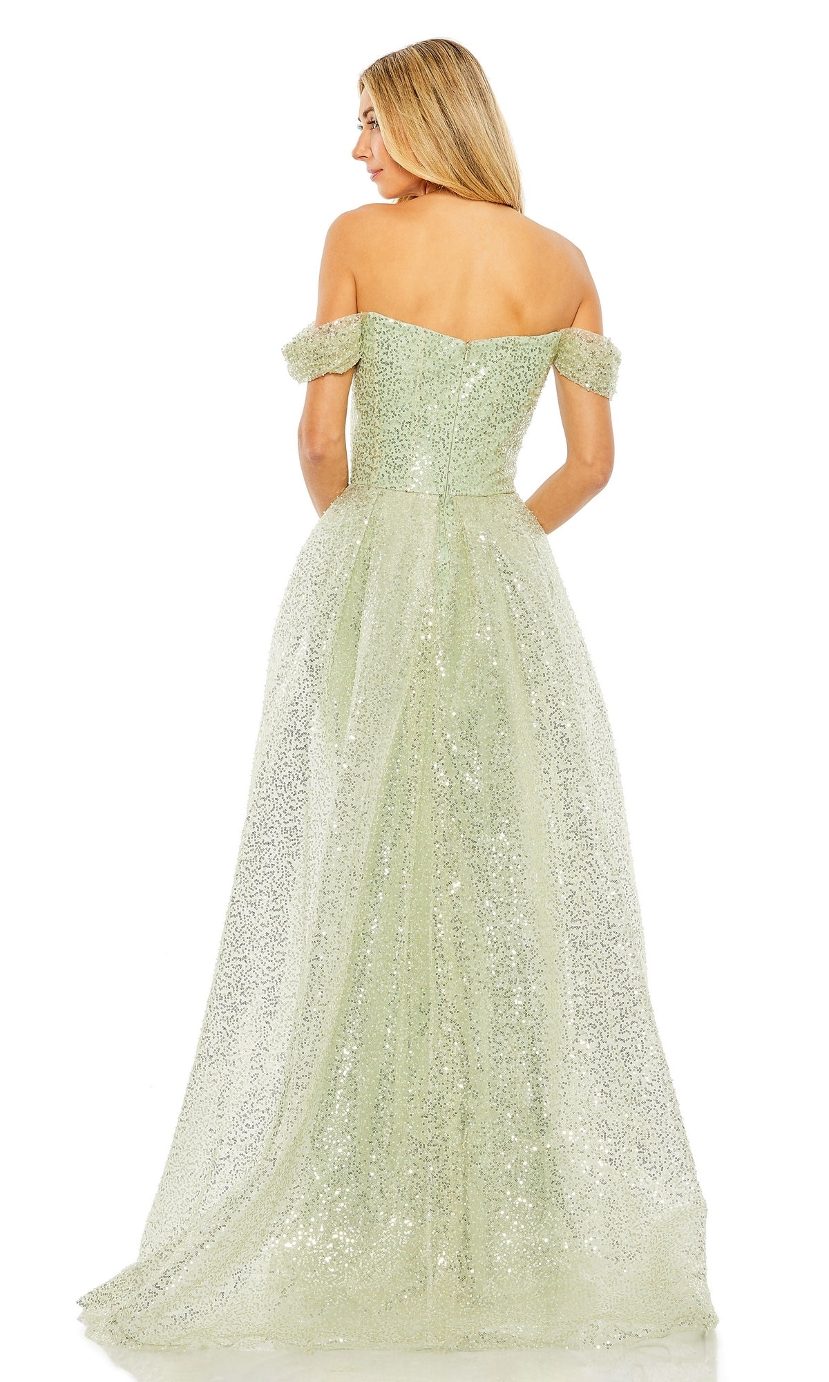 A woman with long blonde hair is seen from the back wearing the Mac Duggal 20515, an off-shoulder floor-length light green sequin formal dress.